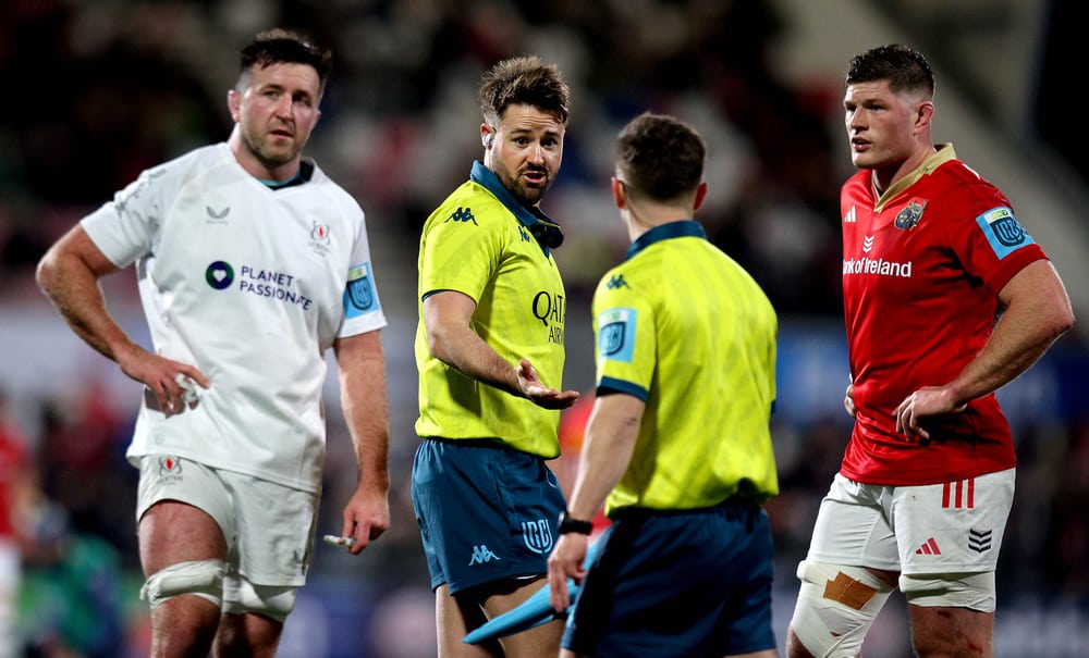 Ben Whitehouse speaking with another match official between rugby players