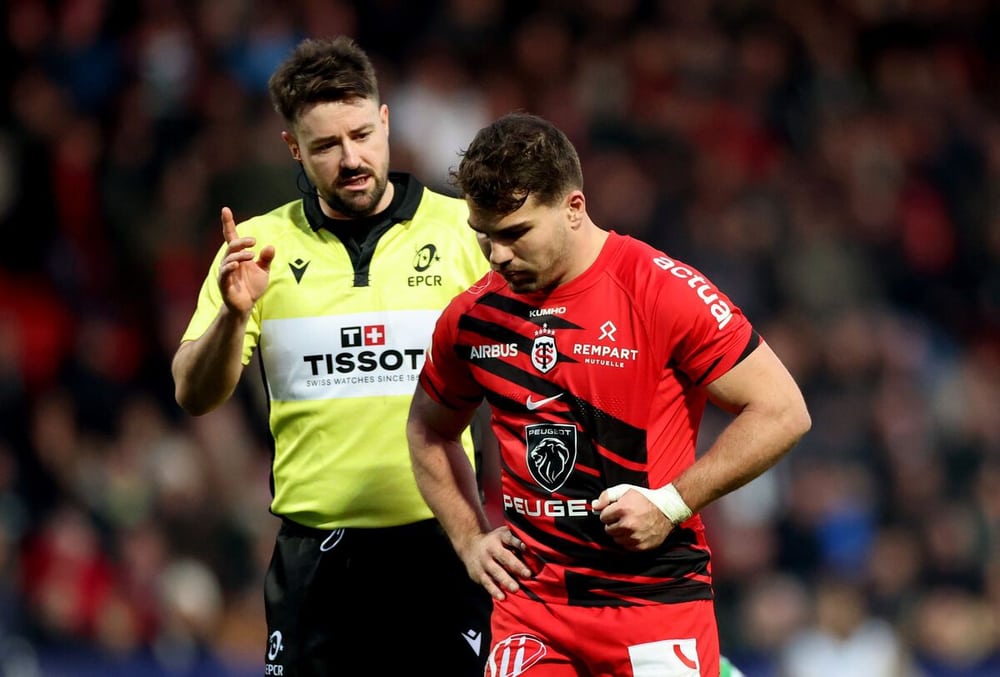 Ben Whitehouse gesturing beside a rugby player in a red and black shirt