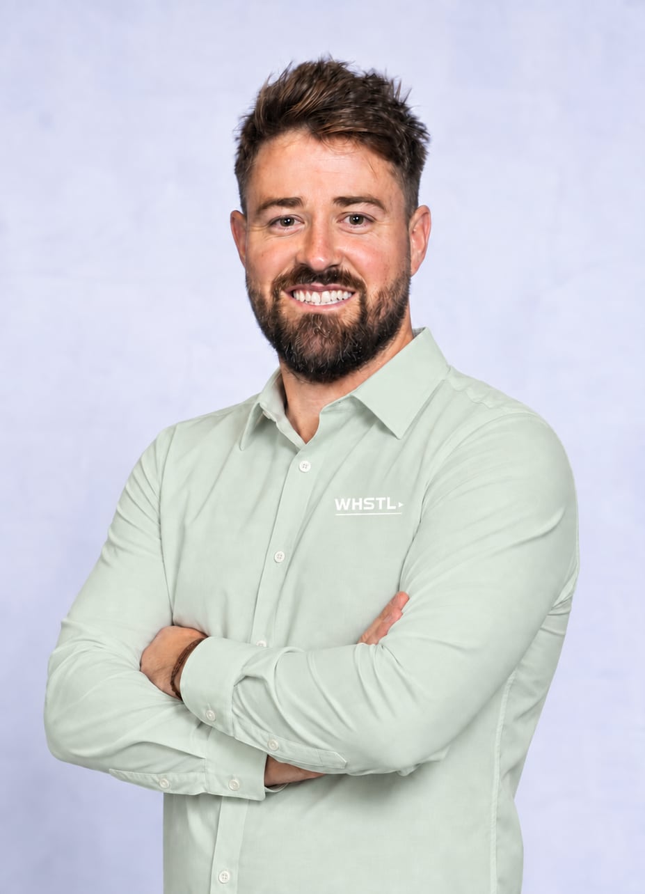 Ben Whitehouse smiling in a sage shirt with the white WHSTL logo